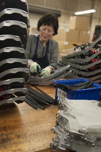 Kinh, an MSR employee for 12 years, assembles snowshoe bindings