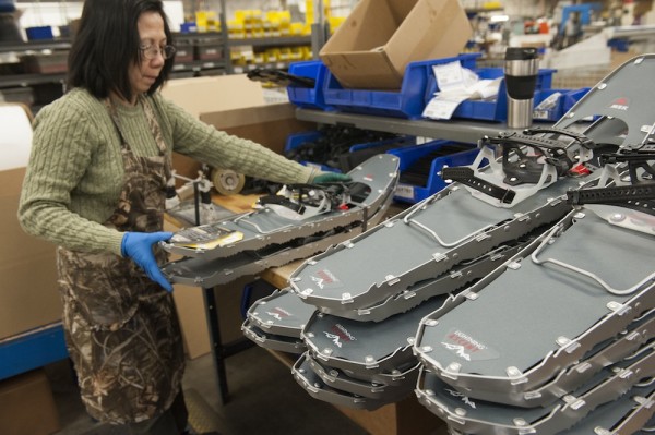 Kieu, an MSR employee for 15 years, assembles snowshoes in their final packaging stage