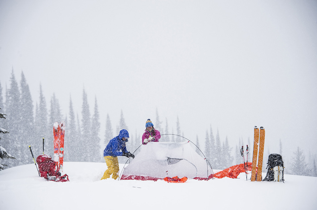 setting up tent in snow