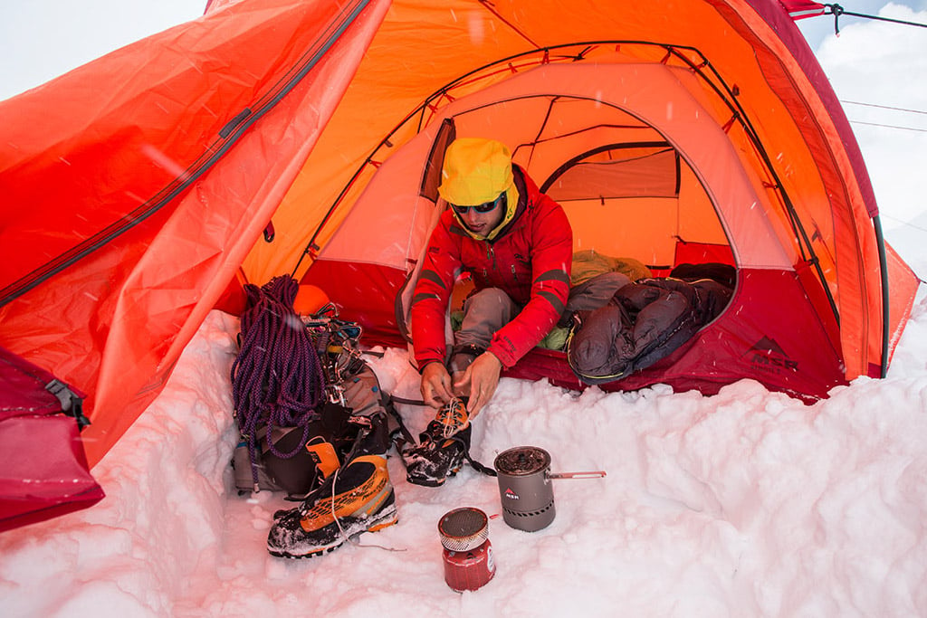 alpine climber sitting in MSR Remote 3 Tent