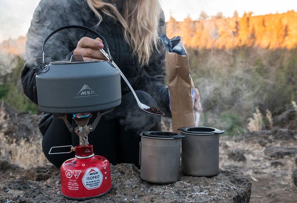 Backpacker prepares coffee with MSR Pika Teapot