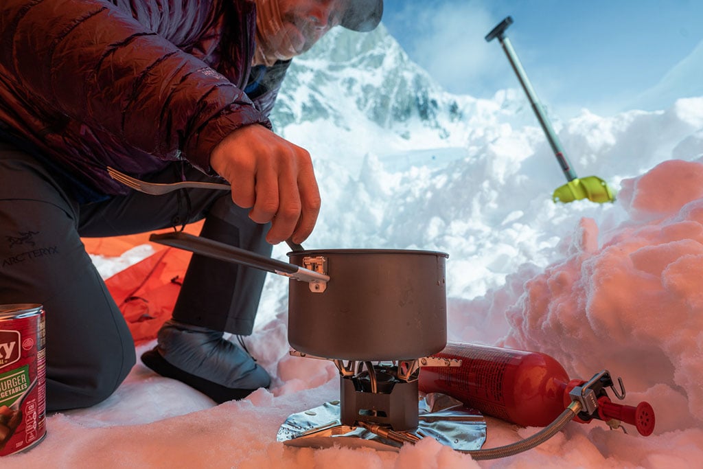 liquid fuel stove cooking in snow