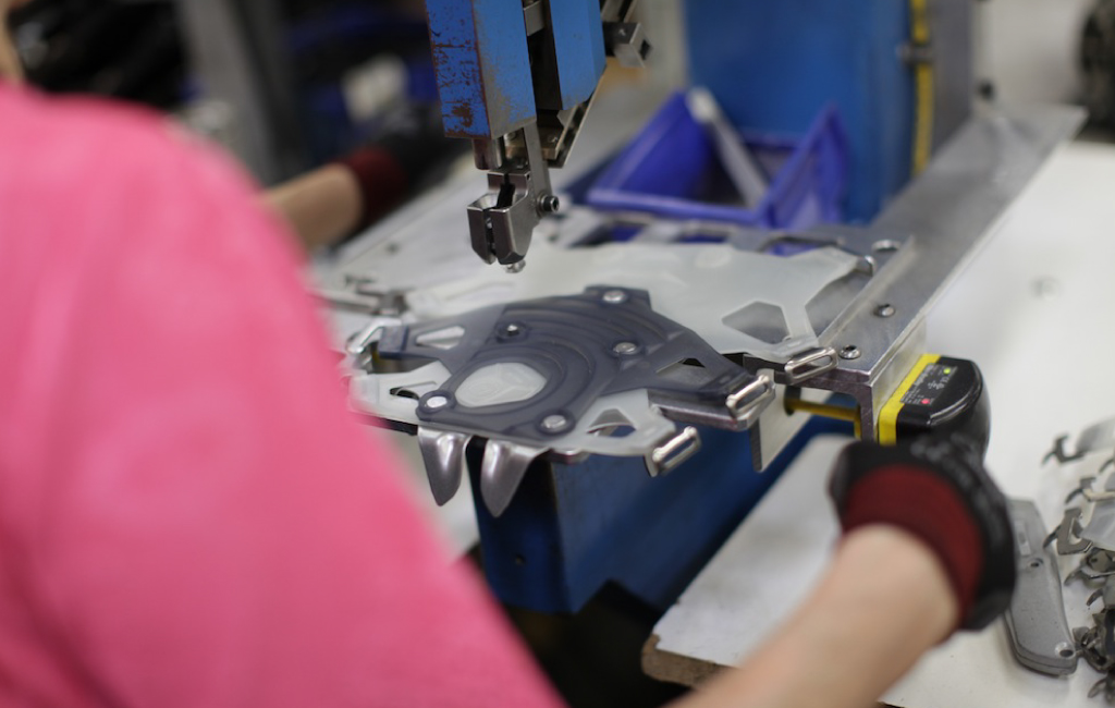 Woman operates machine to create MSR snowshoe bindings
