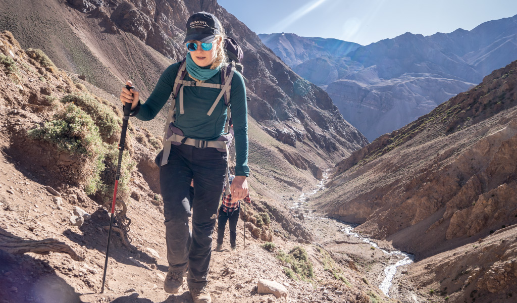 woman hiking with poles in hand