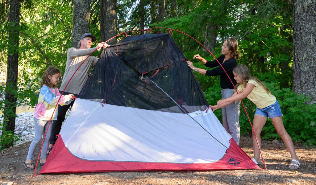 Family of four setting up Habiscape 6 Person tent