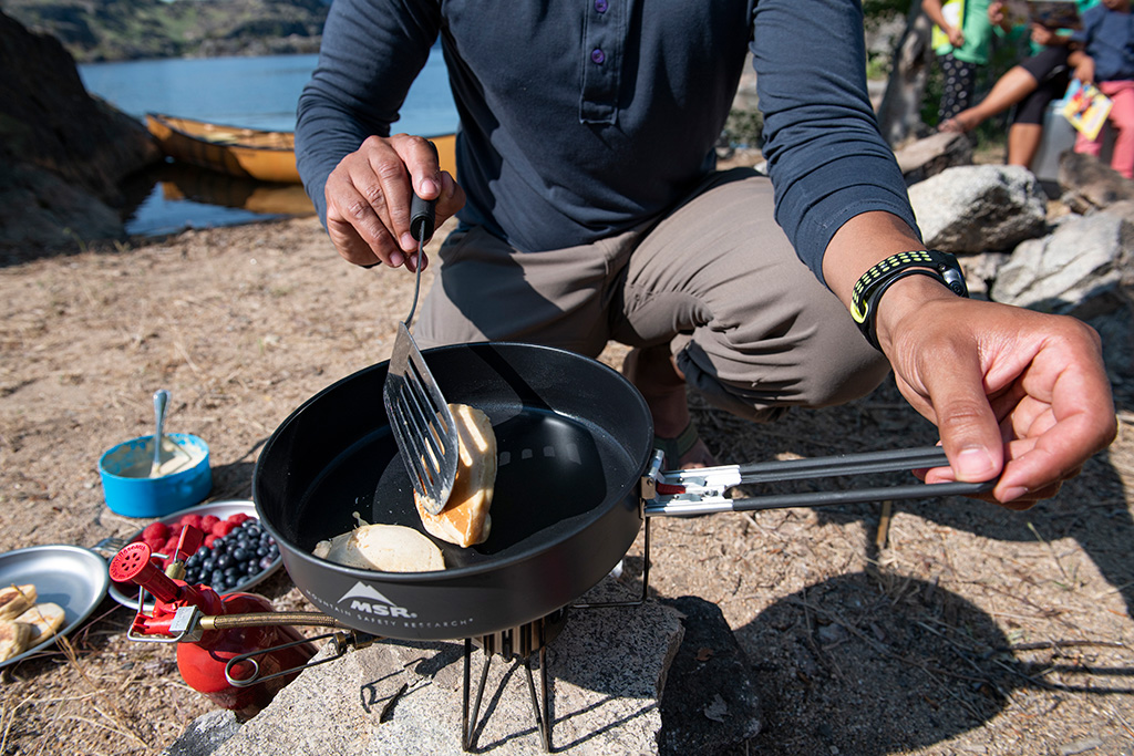 cooking pancakes on skillet in backcountry